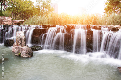 beautiful waterfall with sunbeam