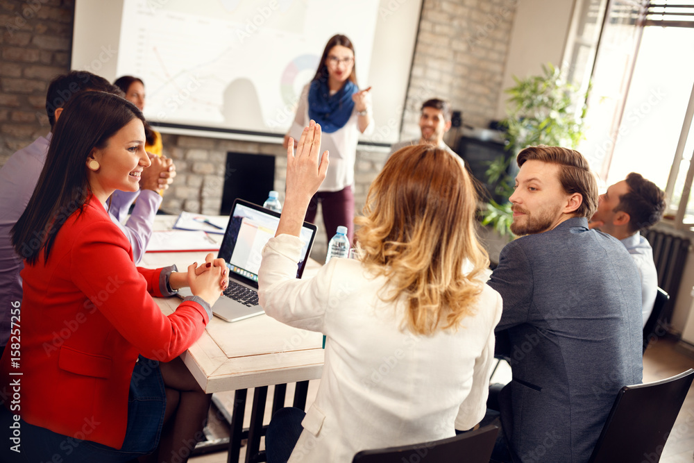 Speaker on business meeting gives word to young woman Speaker on business meeting gives word to young woman