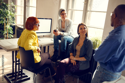 Konstfotografi Female workers with manager in office
