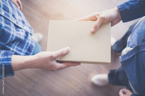 Man handed the Box Paper to each other paper. Box.Cardboard boxes, vintage effect filter style pictures