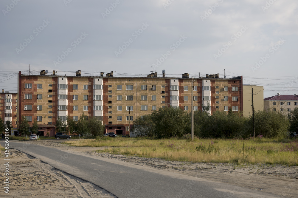 Modern five-storeyed house with flats. It was colored in red, orange and white colors Modern five-storeyed house with flats. It was colored in red, orange and white colors