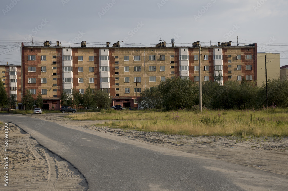 Modern five-storeyed house with flats. It was colored in red, orange and white colors Modern five-storeyed house with flats. It was colored in red, orange and white colors