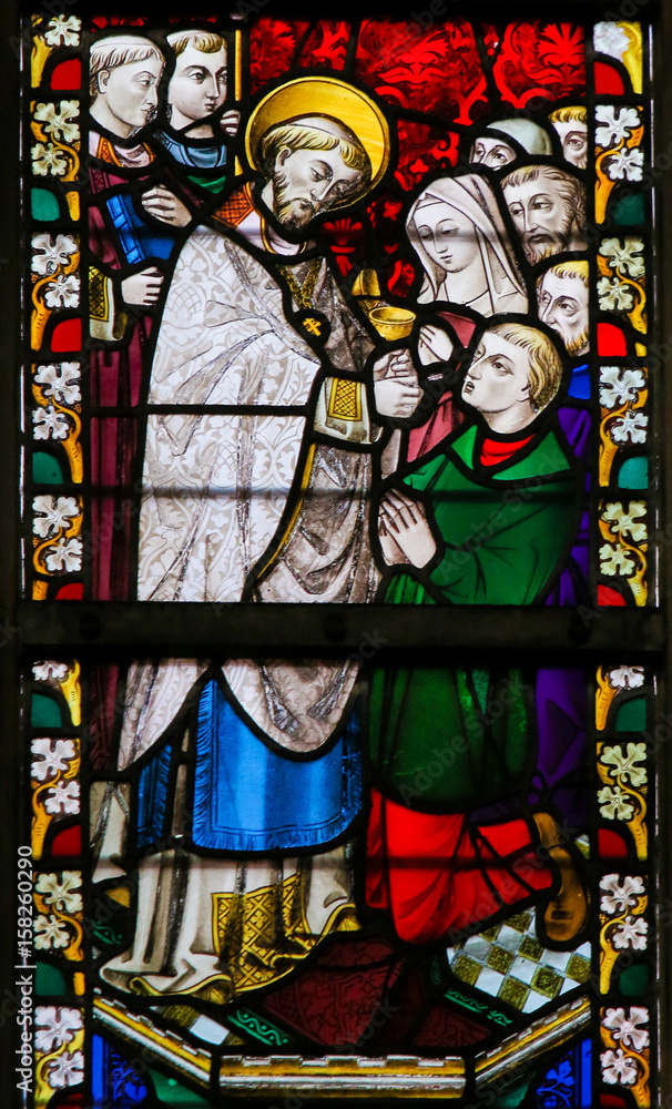 Stained Glass - Priest giving Holy Communion