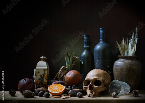 Skull and objects expired and dried and rotten fruits on the plank in dim light night / Still life style  and select focus, space for text.