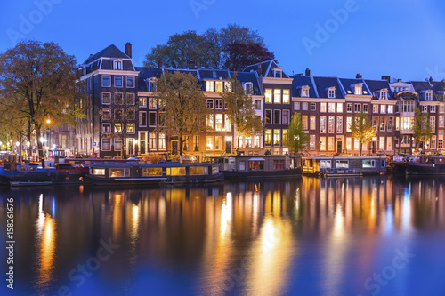 Evening town Amsterdam in Netherlands on bank river canal Amstel