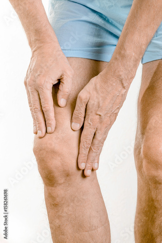 Canvas Print Athlete man massaging a painful  quadriceps and the knee after a sport accident
