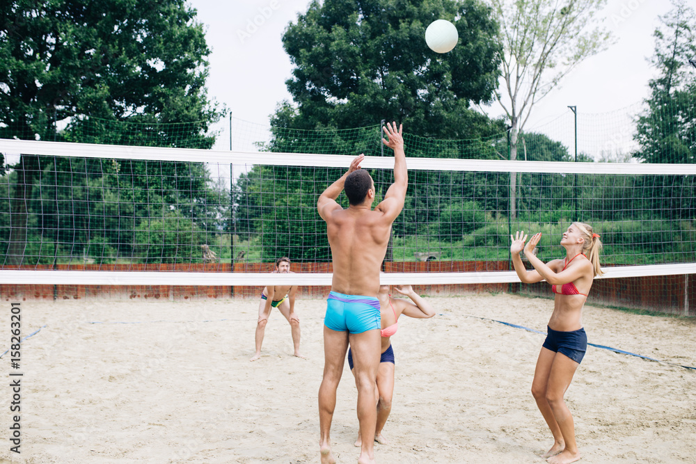 Beach volleyball, people outdoors. 