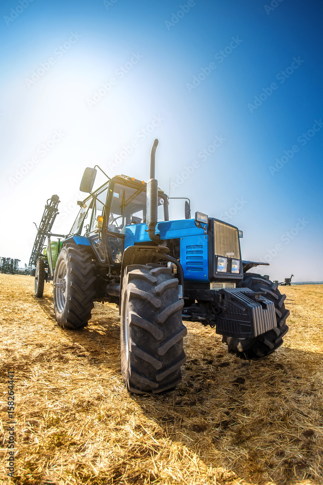 Modern tractor in the field on a sunny autumn day. Modern tractor in the field on a sunny autumn day.