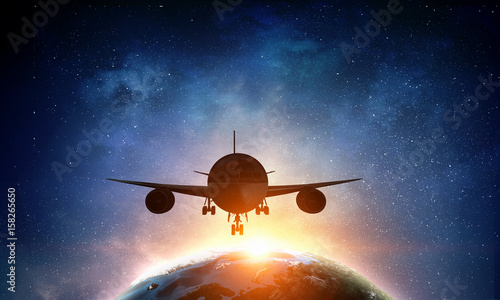 Fototapeta Naklejka Na Ścianę i Meble -  Airliner over Earth planet