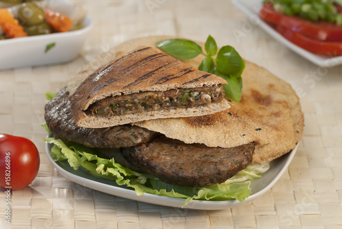 Egyptian Hawawshi  with pita bread and salad photo