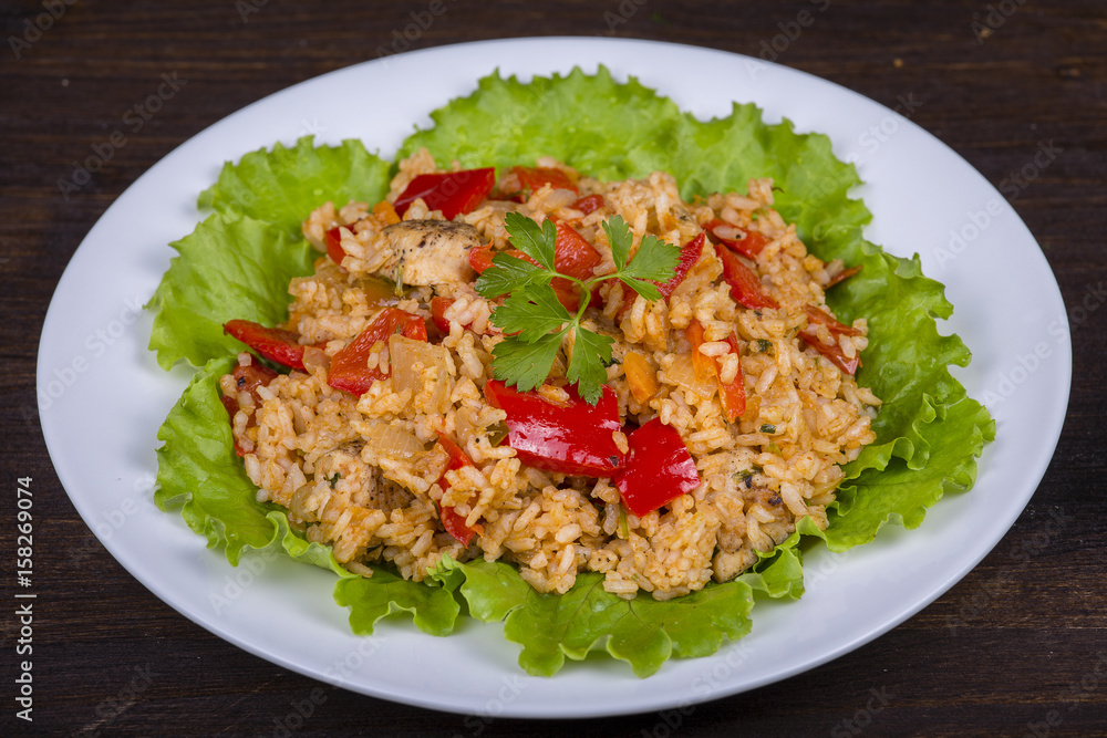 Rice with vegetables and chicken in a curry sauce.