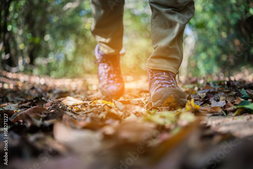 Close up of man feet while hiking in nature.