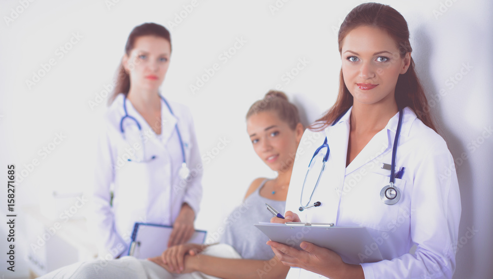 Woman doctor with folder standing at hospital Woman doctor with folder standing at hospital