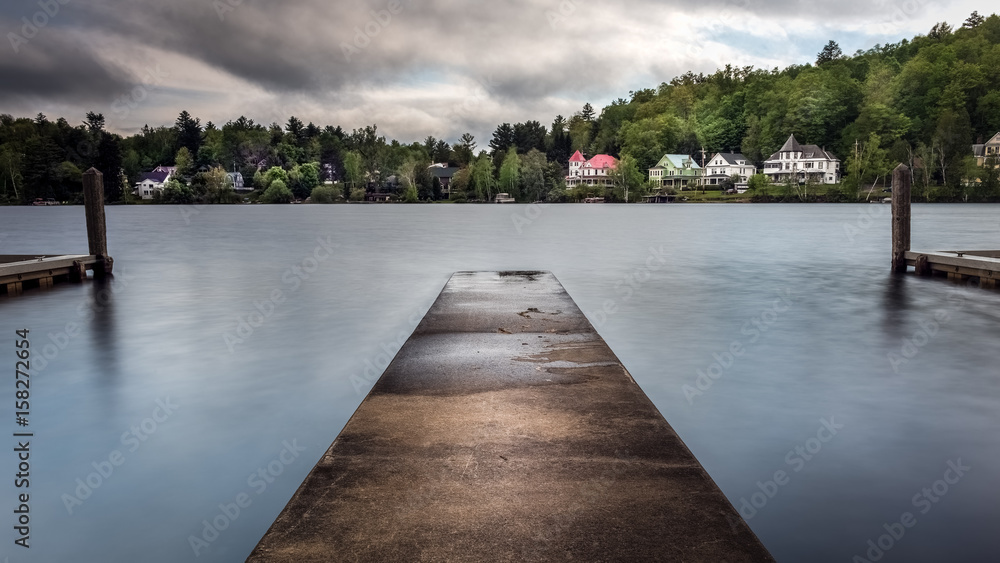 A concrete boat launch ramp jutting out into Lake Flower in the Adirondacks at Saranac Lake, New York