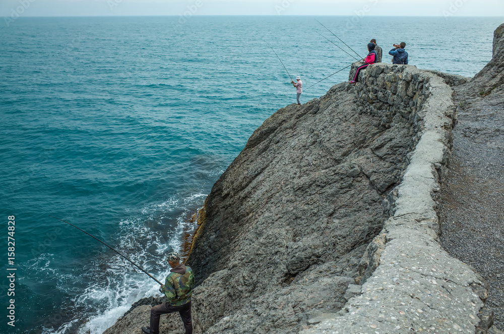 Fototapeta premium Fishermen on the rocks