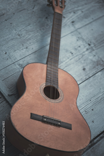 Brown antique guitar on a blue wooden door background
