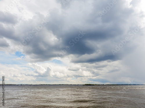 A river landscape. Low dark clouds over the water. Russia, the Volga river.