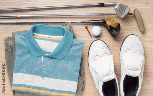 stilll life photography : golf club, clothes and shoes on wood floor background, golfer concept