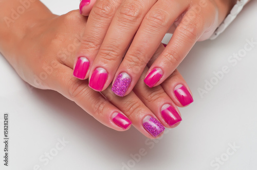Manicure. Pink manicure on square nails. Short nails. Manicure with shiny claws. Isolated nameless nails. A festive pink manicure on kototkie nails. 