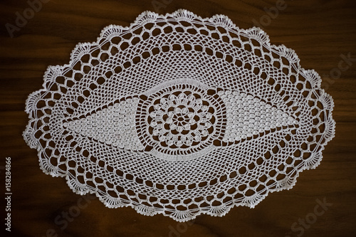Handmade, white crochet, embroidery, on a wooden background, arts