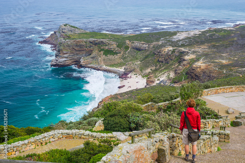 Tourist hiking at Cape Point, looking at view of Cape of Good Hope and Dias Beach, scenic travel destination in South Africa. Table Mountain National Park, Cape Peninsula. photo