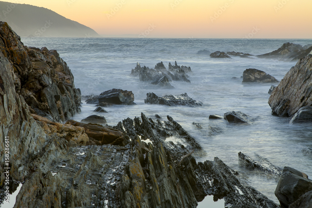 Landscape view of a rocky channel at the mouth of the Storms River in the Tsitsikamma Nature Reserve in South Africa.  A long exposure smoothes the water in this photograph.