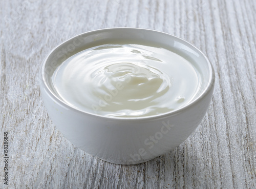 yogurt in white bowl on wood