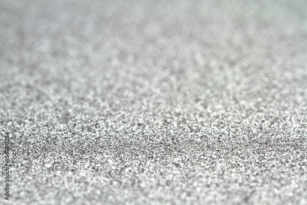 Shiny silver glitter paper defocused texture background. Shiny silver glitter paper defocused texture background.