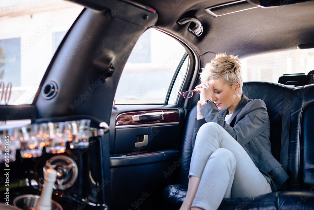 Business woman at limo having stressful day