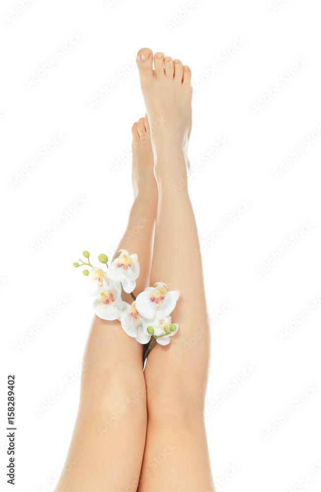 Epilation concept. Legs of beautiful young woman and orchid flowers on white background Epilation concept. Legs of beautiful young woman and orchid flowers on white background