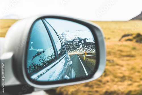 Snow and mountains view on wing mirror © william87
