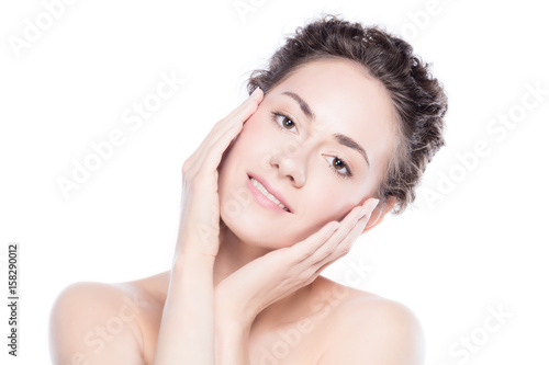 Young, beautiful woman touching her smooth, healthy skin.