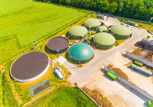 Photography Aerial view over biogas plant and farm in green fields
