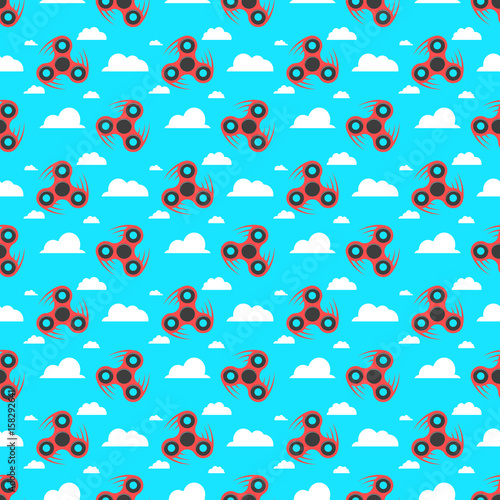 Spinner. A pattern of red spinners in a flat style. Spinners are spinning against the sky. Flat, white clouds. A modern antistress toy for recreation. Play with your fingers