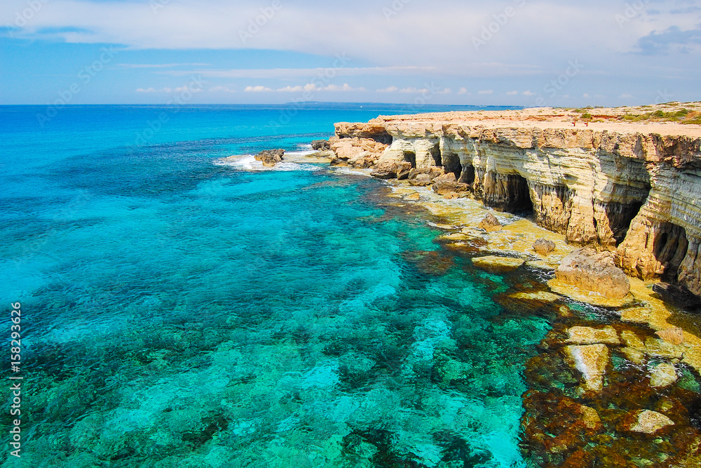Rock cliffs and azure sea water near Cavo Greko peninsula, Cyprus island