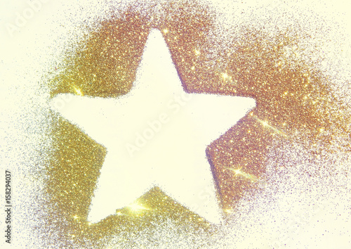 Star on the golden glitter.  Beautiful background for your design. Photographic filters were used, nostalgic colors