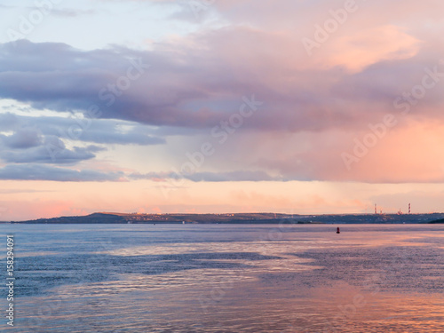 Scenic evening river landscape. Blue and pink sky at sunset. Russia, Saratov city, the Volga river. photo
