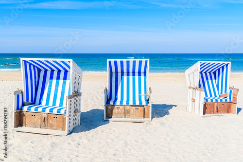Wicker chairs on white sand Kampen beach, Sylt island, North Sea, Germany