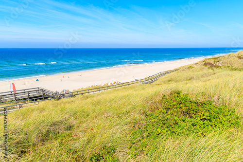 View of Wenningsted beach and grass sand dune on sunny summer day  Sylt island  North Sea  Germany