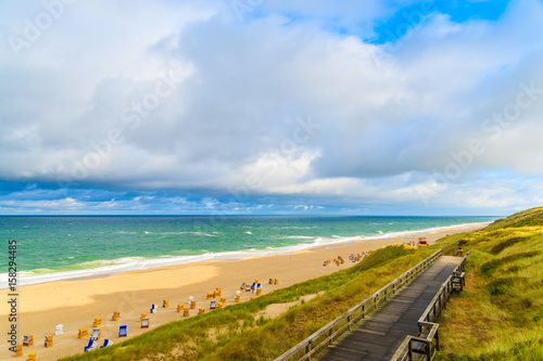 Coastal walkway along Wenningstedt beach at sunrise  Sylt island  North Sea  Germany