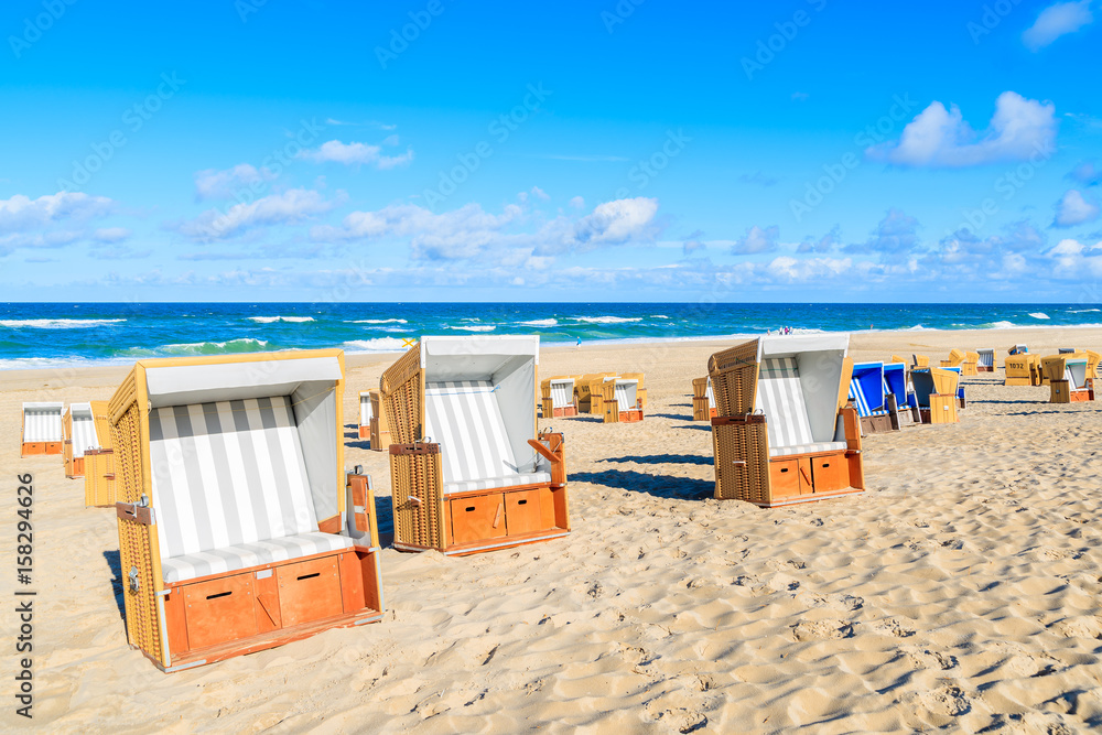 Wicker chairs on sandy beach in Wenningstedt village on Sylt island, North Sea, Germany