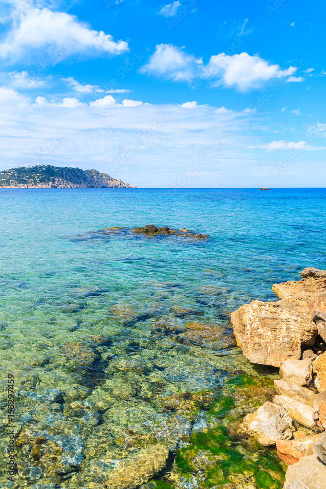 Azure blue sea water on coast of Ibiza island in Es Figueral bay, Spain