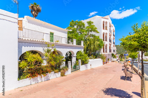 Typical Spanish style houses and tropical plants on street of Sant Josep de sa Talaia town, Ibiza island, Spain photo