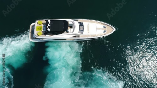 Aerial perpendicular view of a luxury yacht maneuvering.