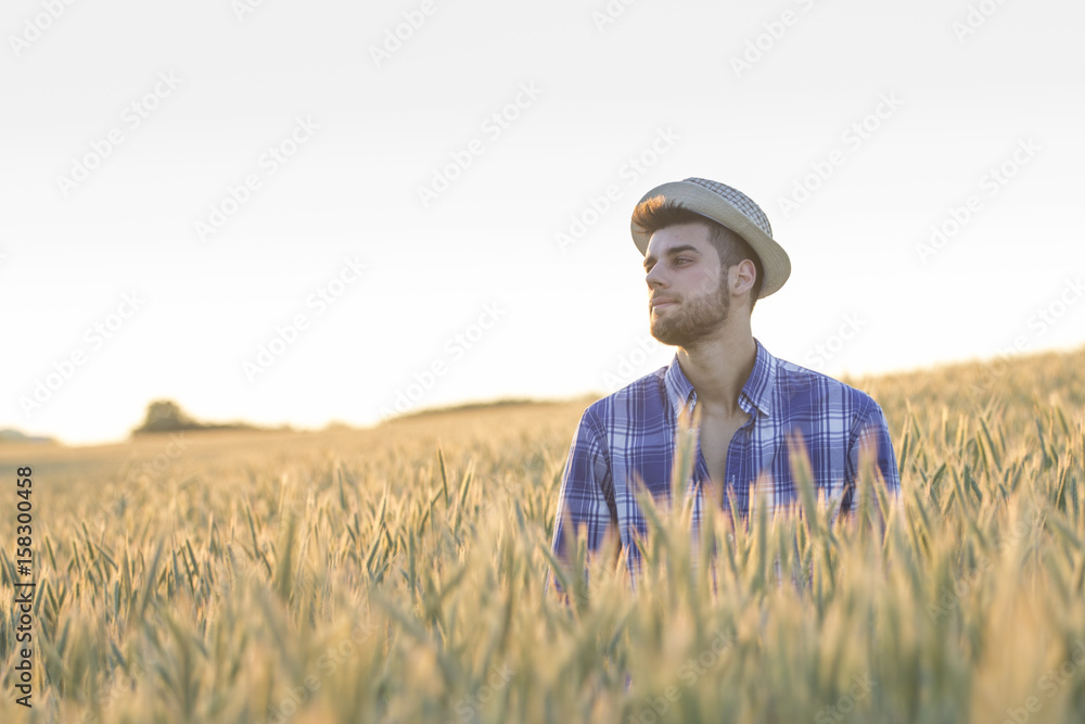 man with hat in the field at the end of day man with hat in the field at the end of day