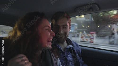 Couple riding together in taxi photo