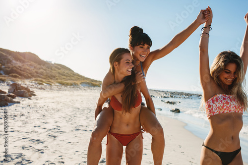 Joyful female friends having fun at the beach