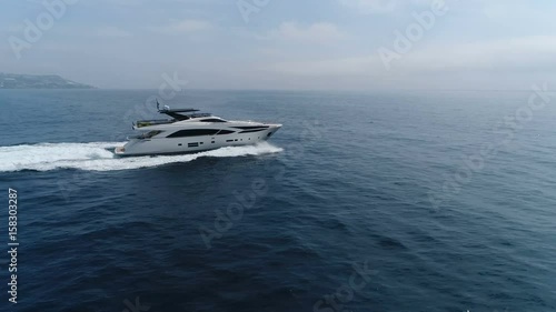 Aerial lateral view of a luxury yacht navigating at open sea.