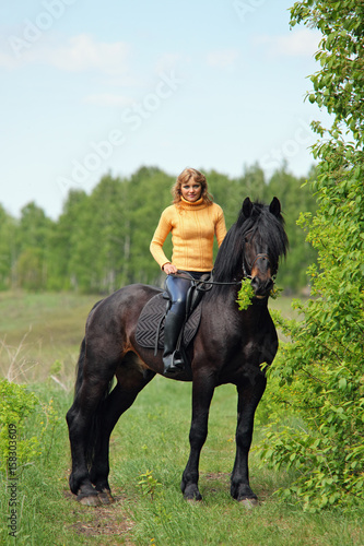 Woman walking horse in forest 