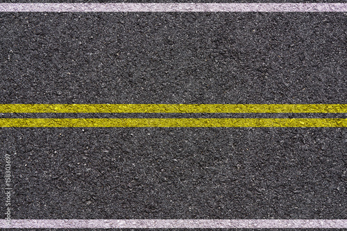 yellow and white double lines on asphalt background